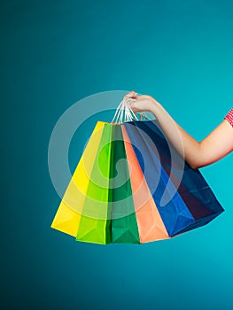 Colorful shopping bags in female hand. Sale retail