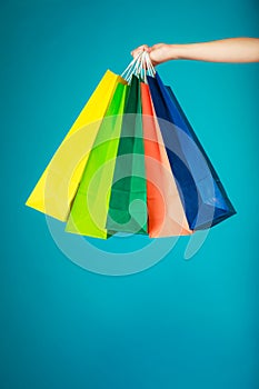 Colorful shopping bags in female hand. Sale retail