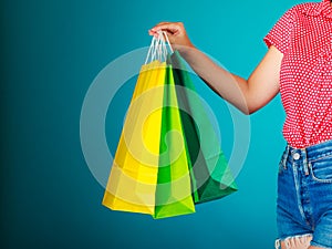 Colorful shopping bags in female hand. Sale retail