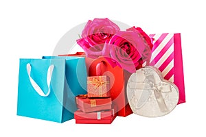 Colorful shopping bags, gift boxes and roses isolated on white