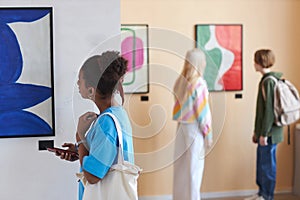 Colorful shot of diverse group of teenagers looking at art