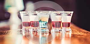 Colorful shots at the club. Alcoholic drink in different colors. Shots at the bar table. Alcoholic drinks in shot