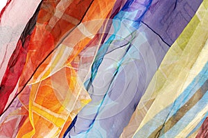 Colorful silk scarfs background photo