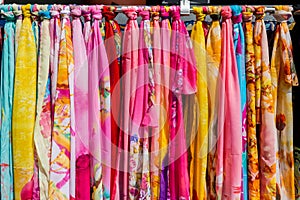 Colorful Silk scarves hanging in market for sale in the gift shops of New Yuanming Palace, Zhuhai, China