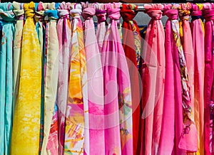 Colorful Silk scarves hanging in market for sale in the gift shops of New Yuanming Palace, Zhuhai, China