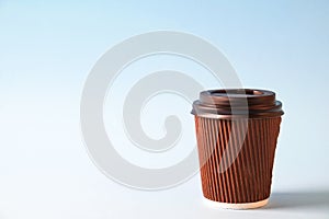 Colorful simplistic minimal composition with heat proof paper coffee cup. Take out tea mug with plastic cap. Coffee shop concept.