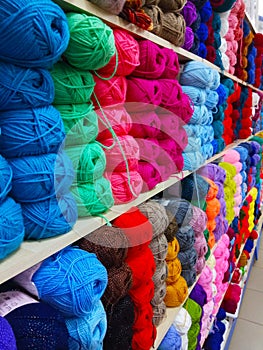 colorful skeins of thread are on the shelves