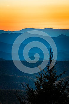 Colorful sky of a setting sun above the ridges of the Blue Ridge mountains in fall