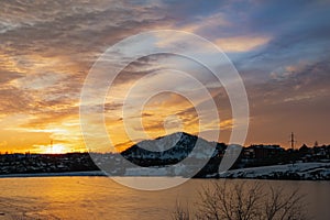 The colorful sky at sunset on a clear day plays with several colors , contrasting and rich beautiful view of the glow near the mou