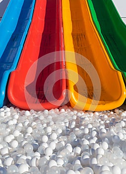 Colorful slides and a bed of cushioning balls photo