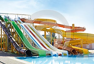 Colorful slides in water park on sunny day