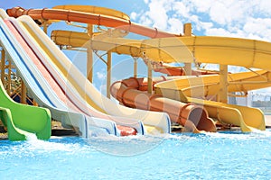 Colorful slides in water park on sunny day