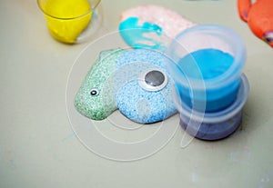 Colorful slime and fake eye with container for kid activity concept