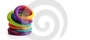 Colorful slinky toy on white background. Plastic rainbow spiral tube. 3d render illustration