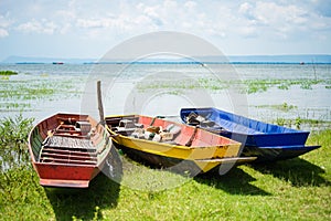 Colorful small fishing boats with anchor stones to stabilize and
