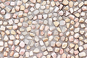 Colorful small stone texture decorative on concrete wall for exterior background