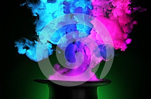 Colorful smoke coming out from a magician hat