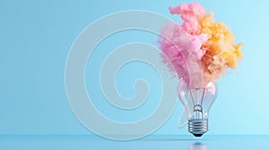 Colorful smoke exploding from a light bulb creating a vibrant and dynamic visual on a blue background