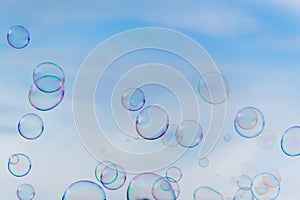 Colorful soap bubbles against blue sky background