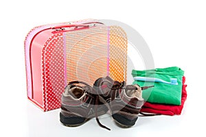 A colorful spare suitcase with shoes