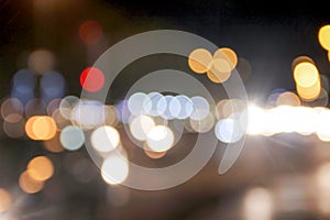 Colorful sparkle bokeh patterns from the  road in night time , abstract  blurred image background