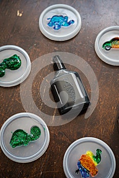 Colorful sparkle glitter glue. Arts and crafts on wooden background