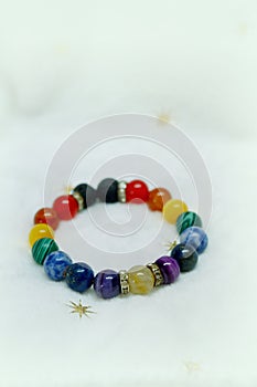 Colorful spectrum lucky stone bracelet bead on white towel background.fashion with believe in Add charm,property, healthy