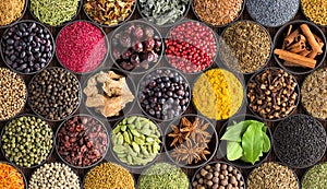 Colorful spice background, top view. Seasonings and herbs for In