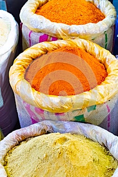 Colorful spices powders of curry and chilli traditional spicy street market in New Delhi. India