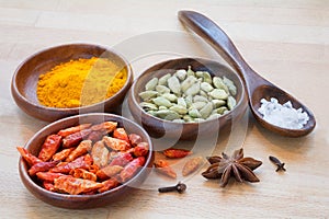 Colorful spices in wooden bowls