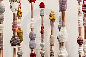 Colorful spindles in front of white wall