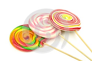 Colorful spiral lollipops on white background