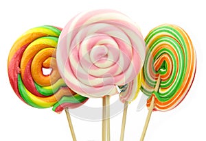 Colorful spiral lollipops on white background