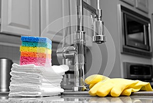 Colorful sponges and gloves in kitchen