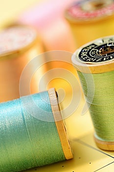 Colorful spools of pastel colored thread