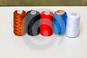 Colorful spools of sewing thread isolated on white background