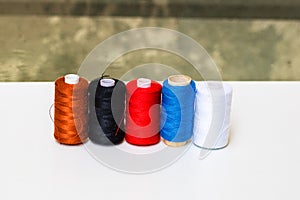 Colorful spools of sewing thread isolated on white background