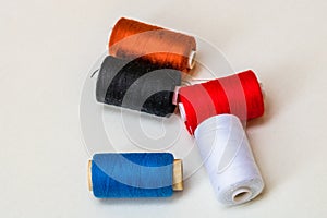 Colorful spools of sewing thread isolated on white background