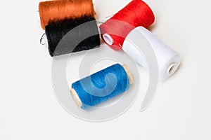 Colorful spools of sewing thread isolated on white background