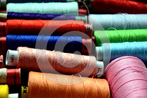 Colorful spools of sewing threads in closeup view