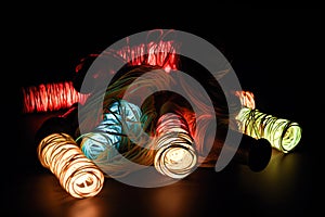 Colorful spools of thread on a black background, close up. Generative AI