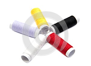 Colorful spools of thread isolated on white background.