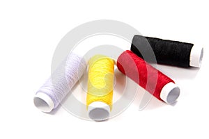 Colorful spools of thread isolated on white background/