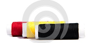 Colorful spools of thread isolated on white background/