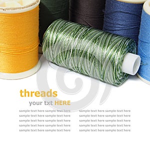 Colorful spools of thread isolated on white background