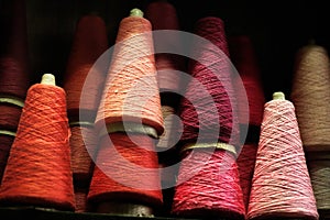 Spools of thread Red Pink background in a vintage shop in Paris France photo