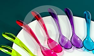 Lots of bright coloured spoons.