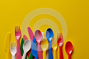 Colorful spoons on a yellow background.