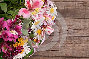 Colorful Spring bouquet of flowers on the wooden background.