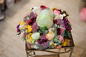 Colorful spring composition with multicolor flowers and big egg candle